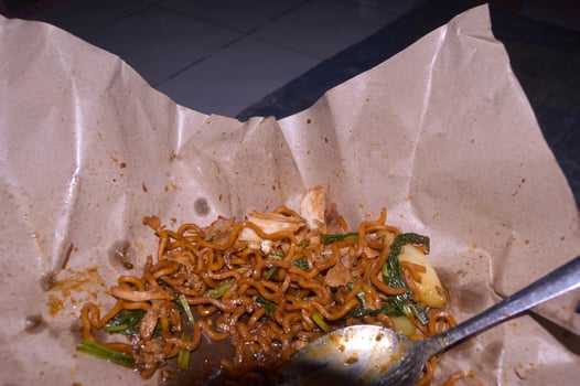 Fried noodles sold on the side of the road in Indonesia. food wrapping paper. photo