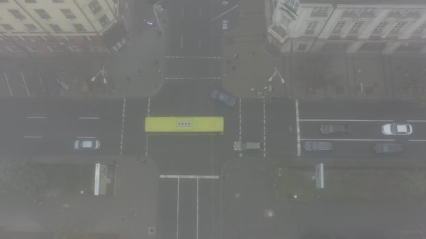 Foggy city street with silhouettes of residential buildings. photo