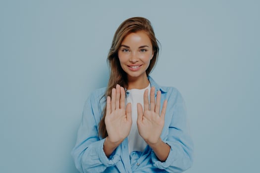 Young beautiful woman in casual clothes standing and holding both hands out photo