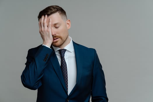 Depressed man in suit feeling sad while receiving bad news photo