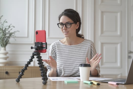 Confident Italian woman economist counselor recording video stream online using smartphone photo