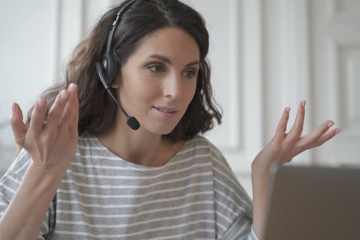 Young spanish businesswoman wearing wireless headphones consulting client online photo