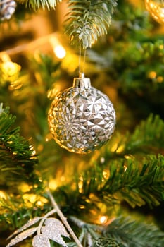 Classic Christmas decorated New year tree. Christmas tree with wite and silver decorations, ornaments toy and ball. Modern classical style interior design apartment. Christmas eve at home. photo