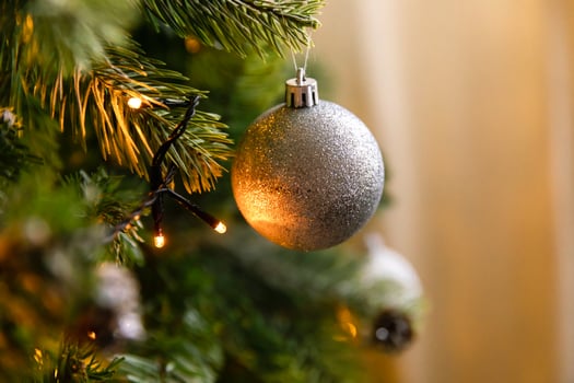 Classic Christmas decorated New year tree. Christmas tree with wite and silver decorations, ornaments toy and ball. Modern classical style interior design apartment. Christmas eve at home. photo