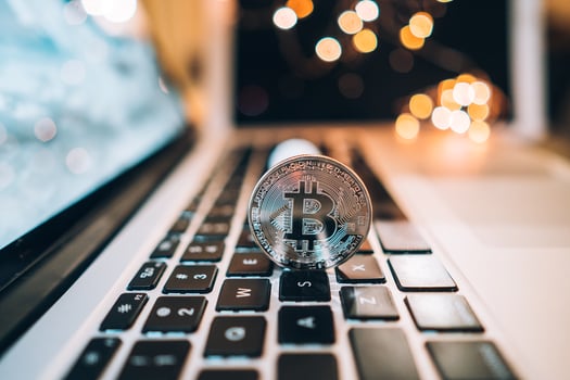 Macro shot of Bitcoins coins on laptop photo