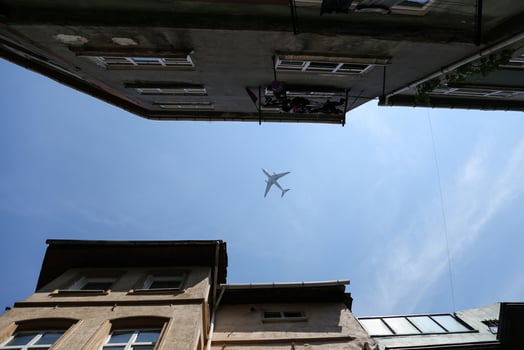 Airplane Passing Over City photo