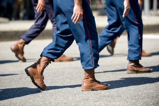 Military marching in a street. Legs and shoes in line photo