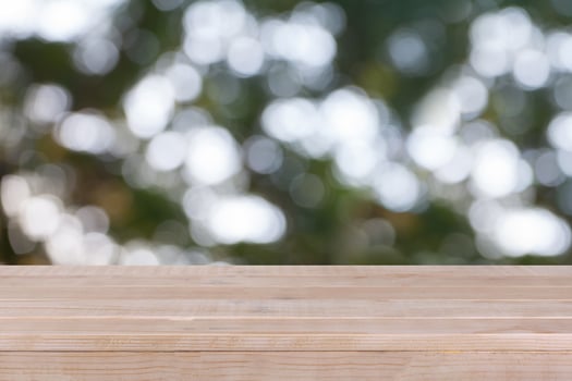 Wood table top on bokeh green background - can be used for montage or display your products photo
