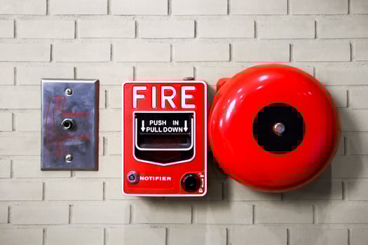 Fire alarm switch on brick wall texture background photo
