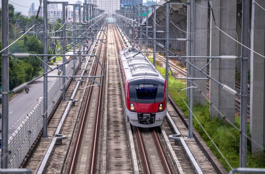 The electric train drives at high speed motion from the station with passenger and cargo to station destination is modern trasportation concept with sun light sky background. photo