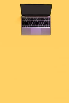 Top view of modern laptop isolated on yellow background. Copy space photo
