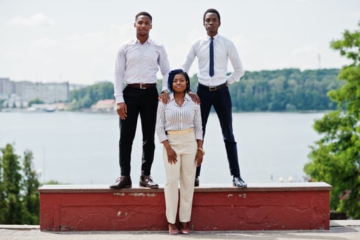 Group of three african american business people posed at street of city. photo