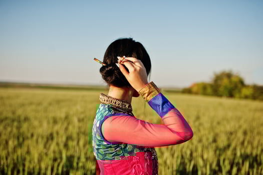 Tender indian girl in saree, with violet lips make up posed at field in sunset. Fashionable india model. photo