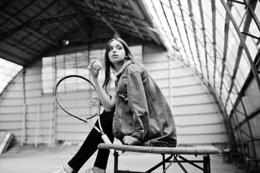 Young sporty girl player with tennis racket on tennis court. photo