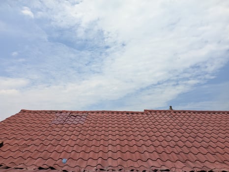 the roof of the house with the warm sun and bright blue sky photo