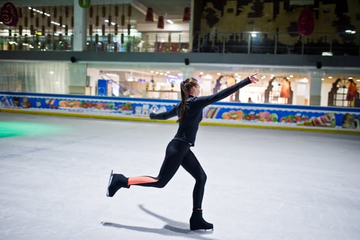 Figure skater woman at ice skating rink. photo