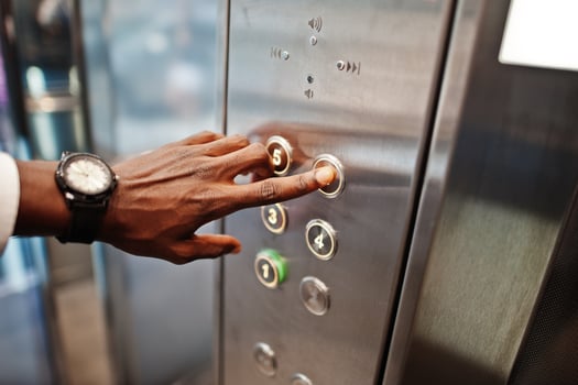 Close up photo of african american man hand with watches at elavator or modern lift, pushing button.