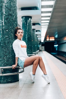 Beautiful young girl posing on metro station photo