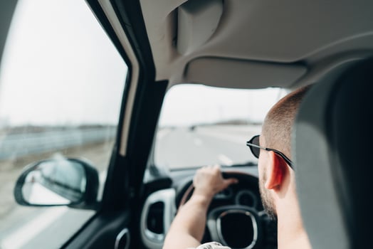 The man in the car traveling on the road photo