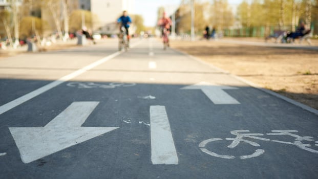 Bicycle symbol on city street against the background of cyclists in a blur. photo