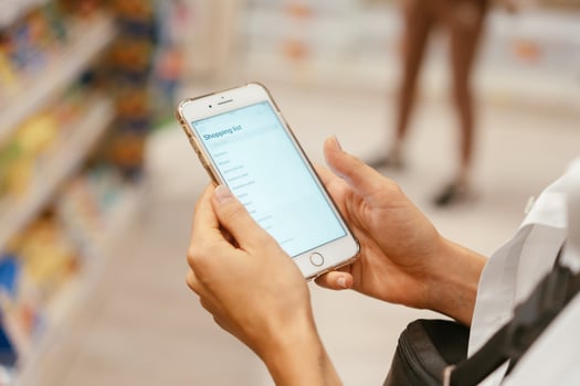 Close up view girl using smartphone in store. photo