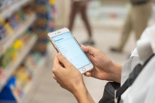 Close up view girl using smartphone in store. photo
