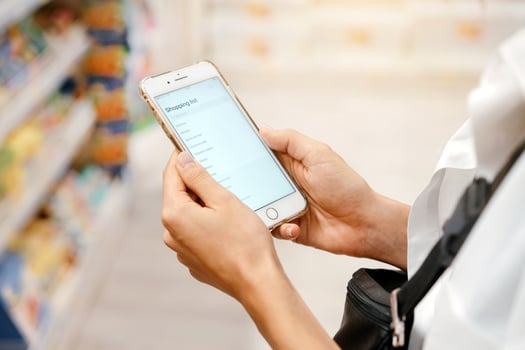 Close up view girl using smartphone in store. photo