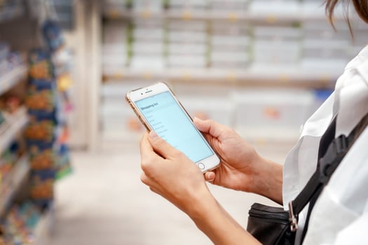 Close up view girl using smartphone in store. photo