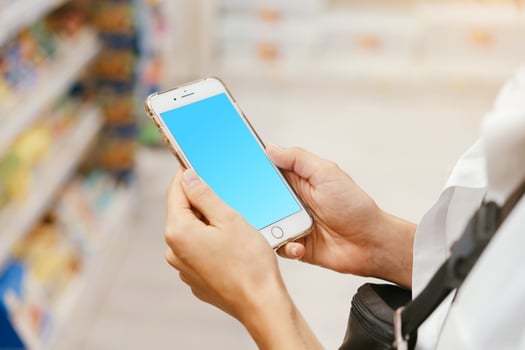 Close up view girl using smartphone in store. photo