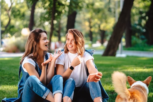 Candid friends seated at the park talking to each other. photo