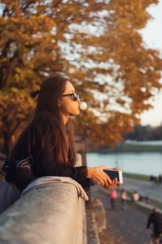 Attractive woman using smartphone outdoors in the park photo