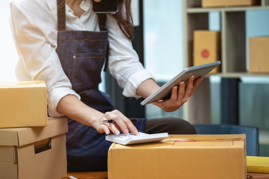Young businesswoman using a tablet to check online product sales photo