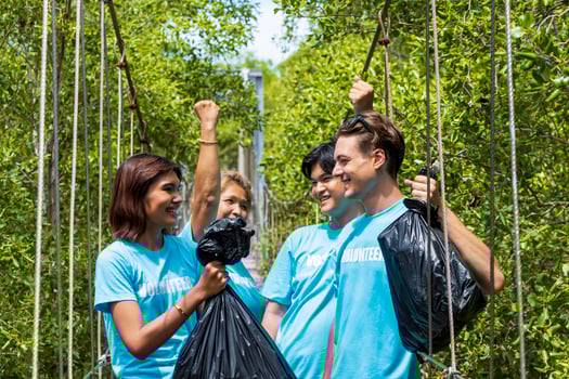 Team of young and diversity volunteer worker group enjoy charitable social work outdoor in cleaning up garbage project at mangrove forest photo