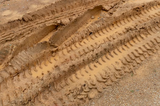 Tilt angle view of liquid mud off road and there are marks of tires. photo