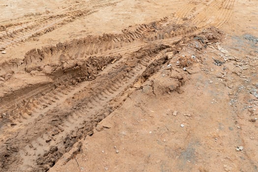 Tilt angle view of liquid mud off road and there are marks of tires. photo