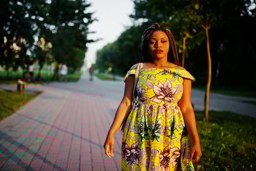 Cute small height african american girl with dreadlocks, wear at coloured yellow dress, posed at sunset. photo