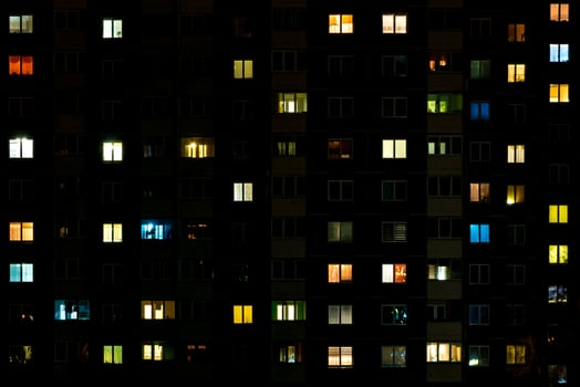 Night time lapse of Light in the windows of a multistory building. life in a big city photo