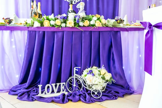 stand for flowers in the form of a bicycle and an inscription love near the festive table photo