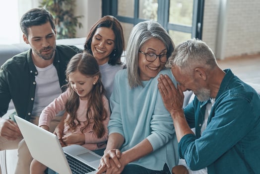 Modern family spending time together and smiling while sitting on the sofa at home photo