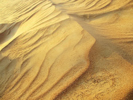 Waves of sand texture. Dunes of the desert. Desert dunes sunset landscape. photo