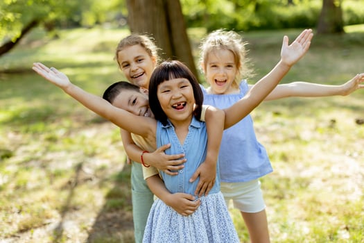 Group of asian and caucasian kids having fun in the park photo