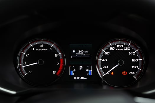 close up modern mileage car dashboard instrument panel interior with warning lights, seat belts and handbrake lights. Miles Speedometer photo