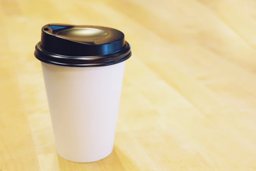 paper coffee cup color white on on table top at cafe. wooden background photo