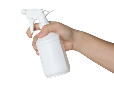 hand holding a spray bottle isolated on white photo