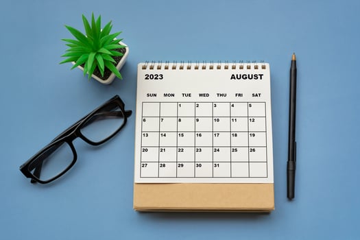 August 2023 desk calendar on blue background. Directly above. photo