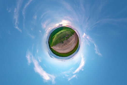 Little planet transformation of spherical panorama 360 degrees. Spherical abstract aerial view in field in nice evening with awesome beautiful clouds. Curvature of space. photo