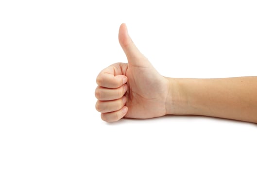 Woman hand thump up sign isolated on white background photo