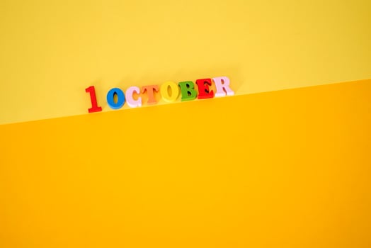 October 1 . First Day, October 1 wooden calendar on yellow abstract background. photo