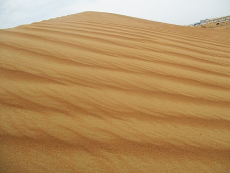 Waves of sand texture. Dunes of the desert. Desert dunes sunset landscape. photo