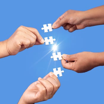 Hands holding jigsaw puzzles piece with clear blue background, success business, solution strategy, teamwork partnership concept photo